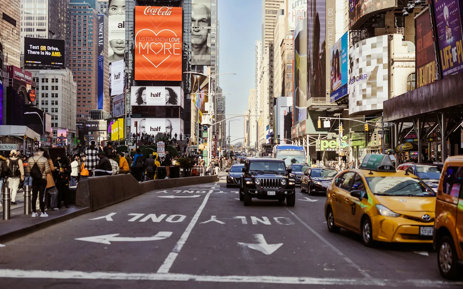 Times Square traffic, pedestrians and city buildings in New York, United States
